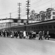 Remaining residents watch the mass evacuation of Japanese from on overhead bridge on Bainbridge Island, Washington, 1942.